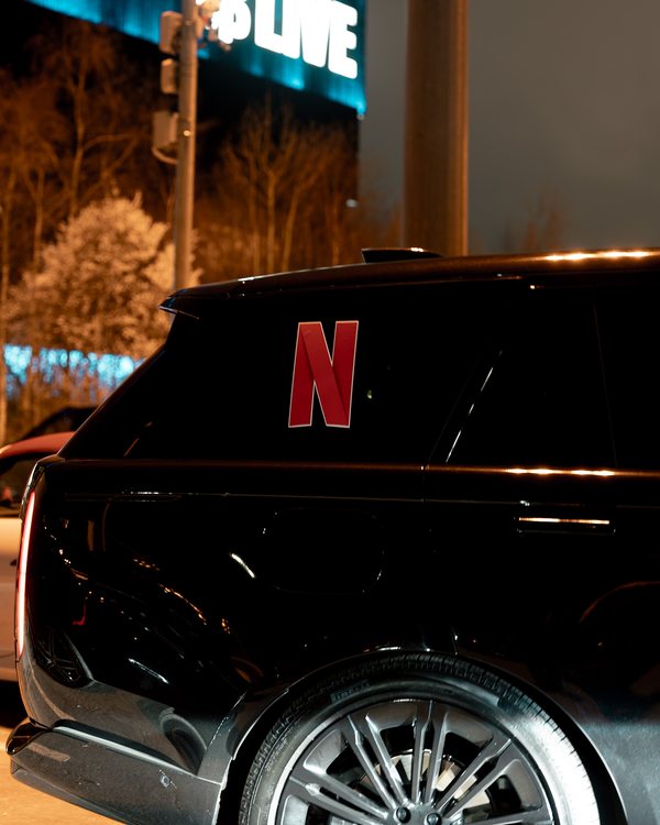 An R5 Range Rover in a client’s branding outside Co-op Live at night