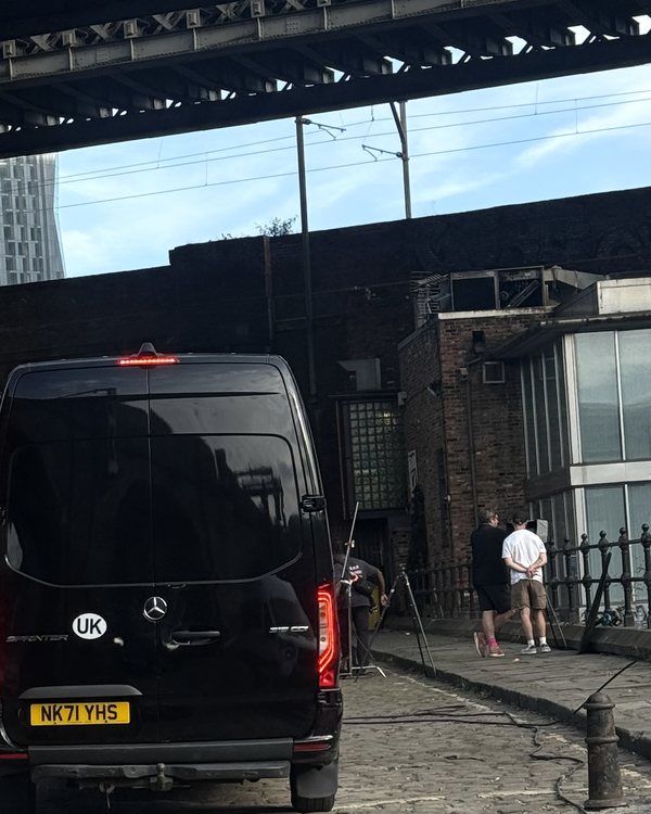 An R5 Mercedes Sprinter parked on the cobbles under the railway viaduct in Castlefield, Manchester, beside a camera rig