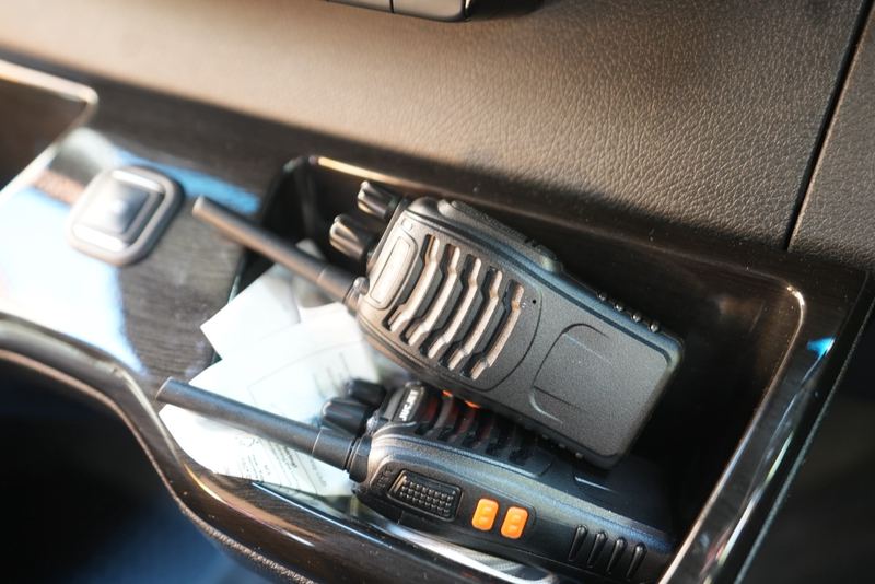 Two crew radios in the cab door pocket of an R5 Sprinter