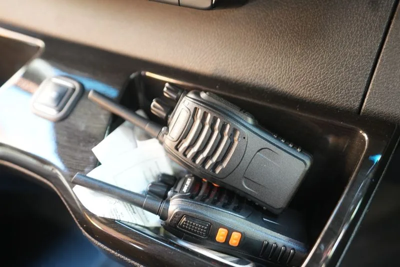 Two crew radios in the cab door pocket of an R5 Sprinter