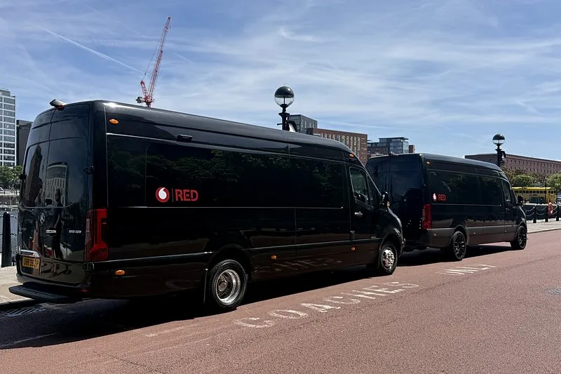 Two R5 Mercedes Sprinters in client livery parked on the Liverpool waterfront