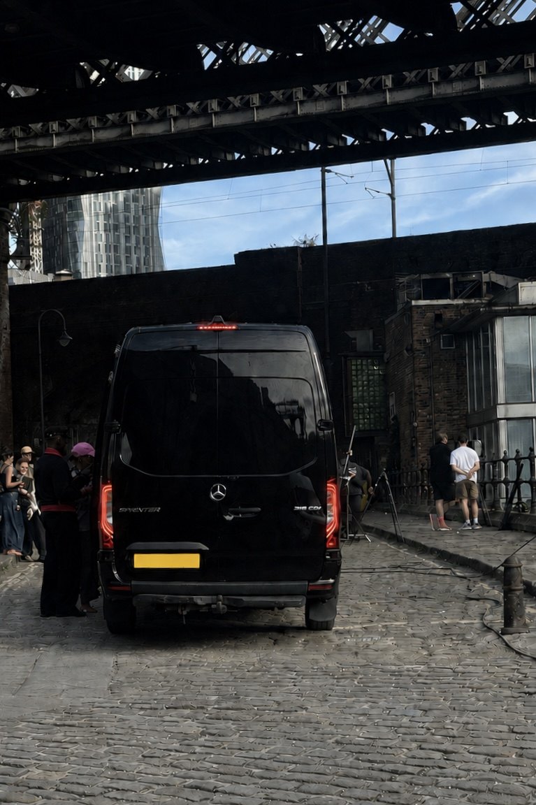 R5 Executive Travel Mercedes Sprinter on a cobbled Manchester location beneath a railway viaduct during an editorial shoot